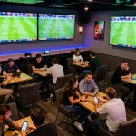 Sports fans engaging in strategic betting on Nowgoal while watching live football matches